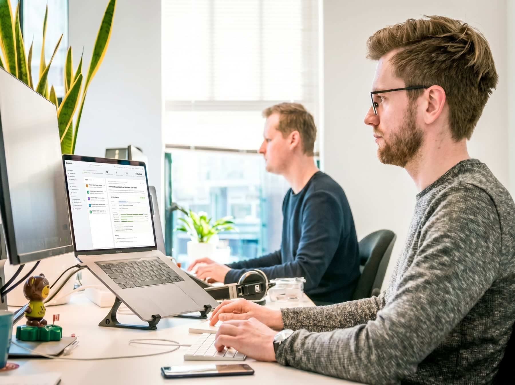 A bid team working at their screens in a modern office